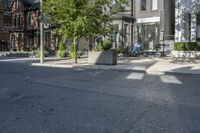 an empty street is full of apartment buildings on a sunny day in toronto, ontario