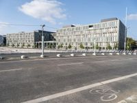 the view of an empty street with traffic in the background and buildings behind it in the background