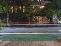 an empty street has been blocked off from traffic with a caution tape, at night