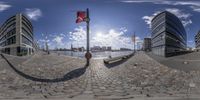 a fisheye lens image shows an empty street and a flag pole outside the city