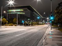 the street is empty as a street light shines brightly against the night sky outside the building