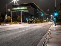 the street is empty as a street light shines brightly against the night sky outside the building