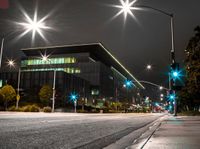 the street is empty as a street light shines brightly against the night sky outside the building