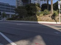 an empty street with a building on the hill in the background and a red line painted across