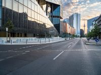 a empty street with buildings on both sides of it and traffic signals in the middle