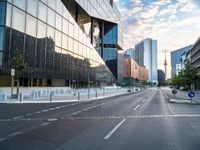 a empty street with buildings on both sides of it and traffic signals in the middle