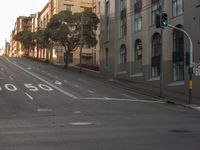 a empty street with lots of buildings at the end and the number 50 on the side