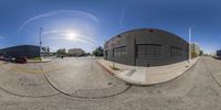 a 360 - view looking photo of a circular shot of an empty street and business center