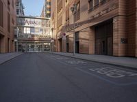 a street and some tall buildings in a city street is empty and there are no cars