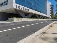 an empty street near a building next to a sidewalk that says mofuk at the top