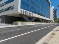 an empty street near a building next to a sidewalk that says mofuk at the top