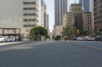 the street is empty except for traffic and trees in the area of the city,