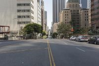 the street is empty except for traffic and trees in the area of the city,