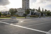 there is an empty street by the castle building during the daytime or afternoon time