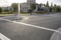 there is an empty street by the castle building during the daytime or afternoon time