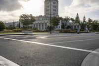 there is an empty street by the castle building during the daytime or afternoon time