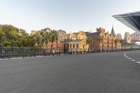 a long empty street with old buildings in the background with white lines in the middle