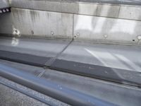 a close up view of an empty street with concrete walls and metal bars and supports