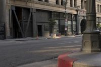 an empty street corner with buildings on either side of the road and an intersection sign that reads no parking