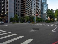 this is an image of an empty street corner that shows cars and people on it