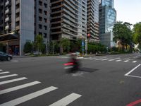 this is an image of an empty street corner that shows cars and people on it