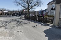 the street corner is empty and it shows signs for cars to stop at the entrance