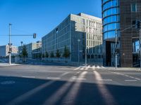 an empty street at a crosswalk in front of some buildings and a bus stop light