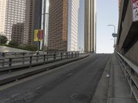 a view of the empty street with several arrows painted on it and tall buildings in the background