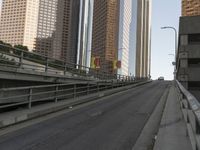 a view of the empty street with several arrows painted on it and tall buildings in the background