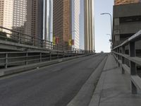 a view of the empty street with several arrows painted on it and tall buildings in the background