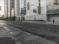 an empty street lined with tall buildings in the middle of downtown los angeles, calif