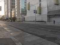 an empty street lined with tall buildings in the middle of downtown los angeles, calif