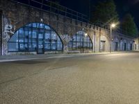 an empty street with graffiti and night sky in background from the corner of a road