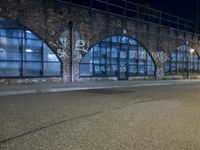 an empty street with graffiti and night sky in background from the corner of a road