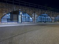 an empty street with graffiti and night sky in background from the corner of a road