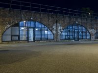 an empty street with graffiti and night sky in background from the corner of a road
