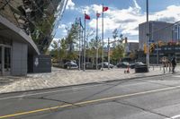 an empty street at an intersection of a street in front of large buildings with glass windows