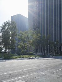 a person walking down a deserted city street with skyscrapers in the background in the daytime