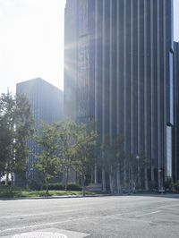 a person walking down a deserted city street with skyscrapers in the background in the daytime