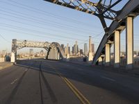 an image of an empty street in a city setting with a bridge in the background