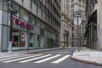 an empty city street with two tall buildings and a sign that reads nemo delect