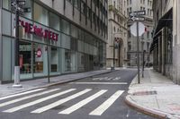 an empty city street with two tall buildings and a sign that reads nemo delect