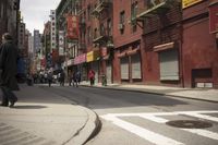 an empty street has a closed garage on the corner near an intersection with parked traffic