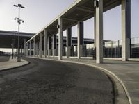 an empty street with parking spaces in the back and one is next to a big building