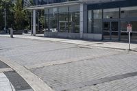 a person sitting at the bench in front of a mall that is empty of people