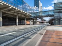 empty street with pedestrian walkway and modern buildings in background in urban area, outdoors in daytime