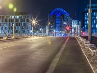 empty street with benches along the street at night time in cityscape of europe