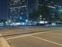 the street is empty but there are no people walking on it at night time in the city