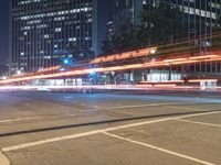 the street is empty but there are no people walking on it at night time in the city