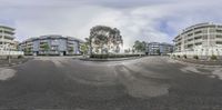 this view shows an empty street with buildings on either side and a stop sign in the middle